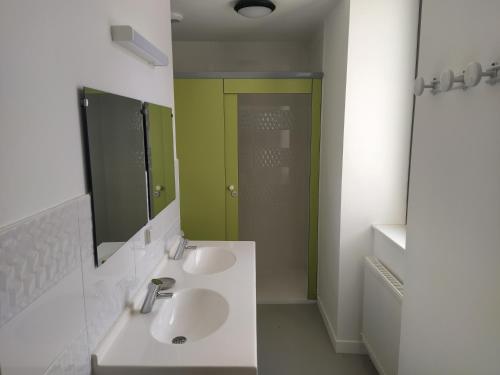 een badkamer met 2 wastafels en een groene deur bij Le Préau de Baix in Baix