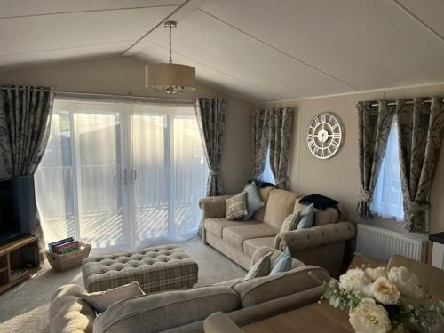 a living room with two couches and a tv at 8 lakeview in Clitheroe