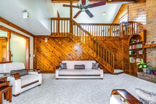a living room with a ceiling fan and a staircase at Spacious Ohio Home about 12 Mi to Downtown Columbus in Worthington