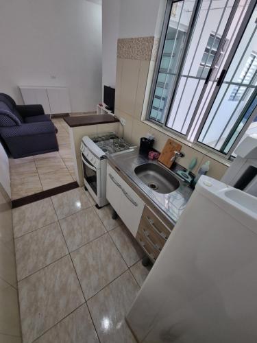 a small kitchen with a sink and a stove at Flat 4 in Sao Paulo