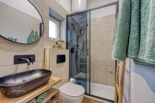 a bathroom with a black sink and a shower at Eva - Storia Parentina in Poreč