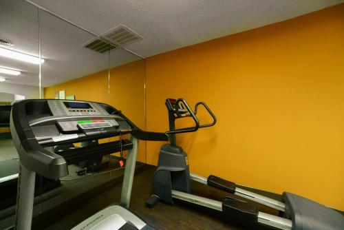 a gym with a treadmill and a yellow wall at Baymont by Wyndham Marion in Marion
