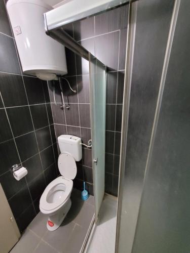 a small bathroom with a toilet in a stall at Kristal 2 in Zrenjanin
