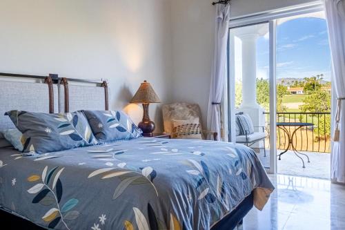 a bedroom with a bed with a blue comforter at Beautiful 2 Bedroom Condo in Palmilla in San José del Cabo