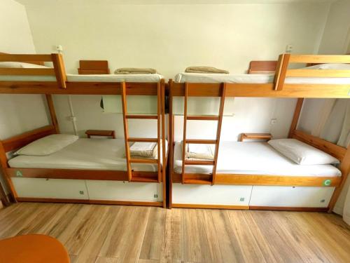 a room with three bunk beds in a room at Jardim Botânico House in Curitiba
