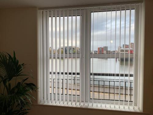 a window with a view of a city at Waterfront view apartment in Lincolnshire