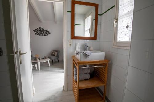 a bathroom with a sink and a mirror at Les granges du chiron in La Garnache
