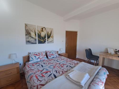 a bedroom with a bed and a desk at UKROPINA APARTMENTS in Trebinje