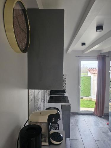 a kitchen with a stove and a clock on the wall at Blue Baroque Rer-C N104-A6 in Brétigny-sur-Orge
