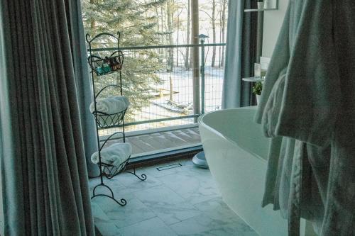 a bathroom with a tub and a window with a view at Roundhouse Grotto in Calgary