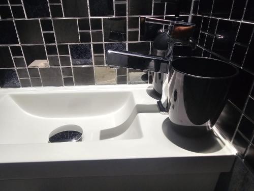 a white sink with a toilet in a bathroom at Blue Baroque Rer-C N104-A6 in Brétigny-sur-Orge