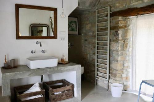 a bathroom with a sink and a fireplace at Villa d'Escale Piemonte with private pool in Monastero Bormida