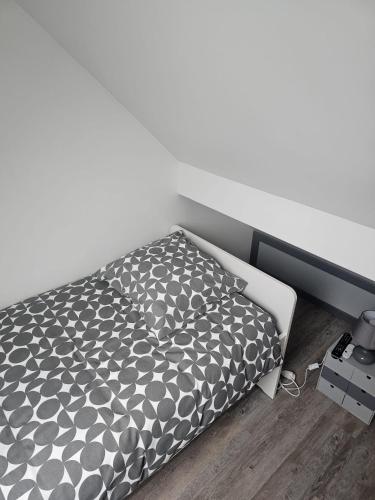 a bed with a black and white comforter in a bedroom at Blue Baroque Rer-C N104-A6 in Brétigny-sur-Orge