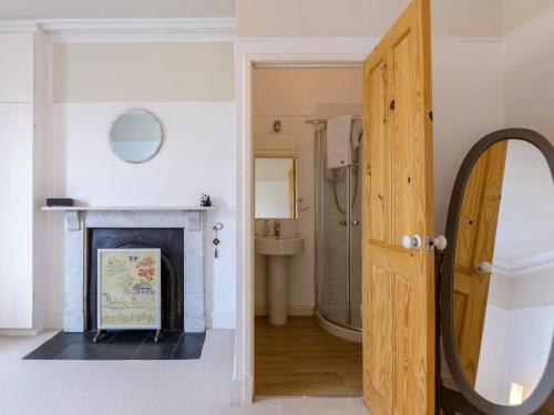 a bathroom with a fireplace and a mirror at 6 Bed in Richmond 6mls 52779 in Catterick Bridge