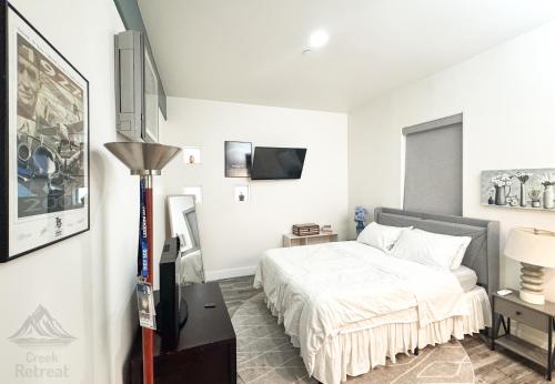 a bedroom with a bed and a flat screen tv at The Creek Retreat - Totally private 1Br/1Bd 