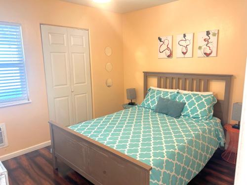 a bedroom with a bed with a blue comforter at Casa California in San Diego