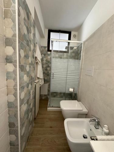 a bathroom with a toilet and a sink and a shower at La casa del fumetto in Castel di Sangro