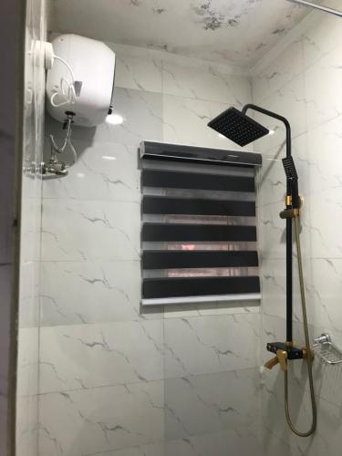 een douche met een douchekop in de badkamer bij Connery Homes in Asaba