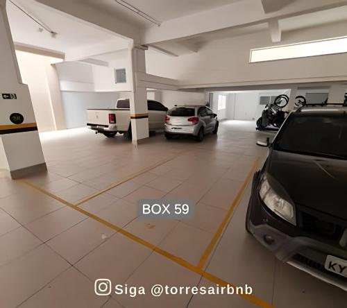 a large garage with two cars parked in it at Apto 02 quartos | Ar | 500mts do mar | Aceita Pet in Torres
