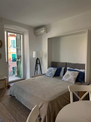 a bedroom with a large bed and a window at Cuore di Lerici , amazing view in Lerici