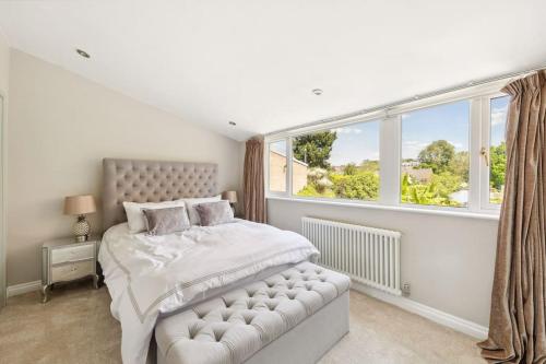 a bedroom with a bed and a large window at Richmond Riverside Villa in Richmond