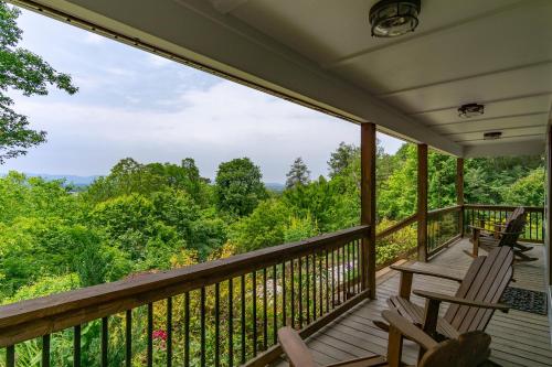 a porch with two chairs and a view of the forest at Mountain Over Main Street 5 Min. to Downtown Weaverville, Fire Pit & Views! in Weaverville