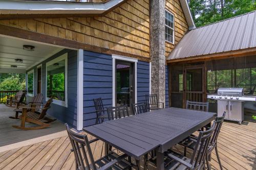 a wooden deck with a table and chairs on a house at Mountain Over Main Street 5 Min. to Downtown Weaverville, Fire Pit & Views! in Weaverville