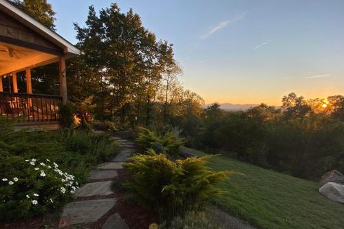 a pathway leading to a house with the sunset in the background at Mountain Over Main Street 5 Min. to Downtown Weaverville, Fire Pit & Views! in Weaverville