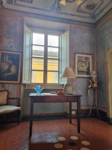 a room with a table in front of a window at il Pozzo Apartment in Città di Castello