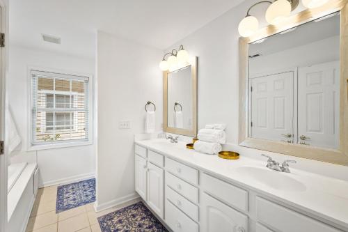a white bathroom with a sink and a mirror at Belmont Oasis I Downtown Cville in Charlottesville