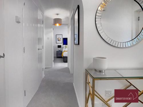 a hallway with a mirror and a hallway with a room at Wokingham - 2 Bedroom Maisonette - With Parking in Wokingham