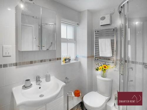 a white bathroom with a toilet and a sink at Wokingham - 2 Bedroom Maisonette - With Parking in Wokingham