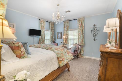 sypialnia z łóżkiem i żyrandolem w obiekcie Grand Mansion-Treasured Mist suite! w mieście Fort Smith