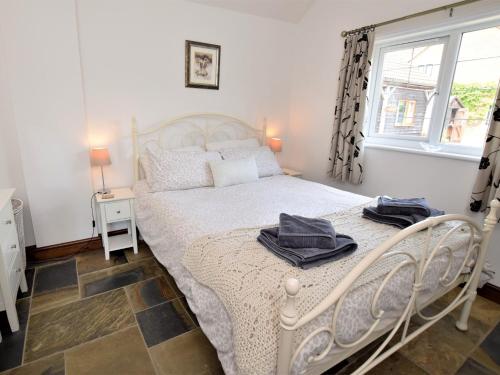a bedroom with a white bed and a window at 1 bed in Bradford-on-Avon 58771 in Erlestoke