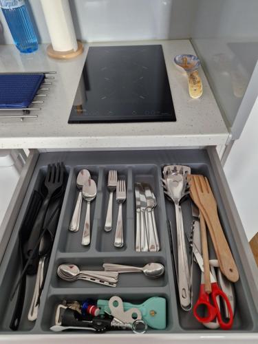 a drawer filled with utensils in a kitchen at Ampuries Delta Apartment in Empuriabrava
