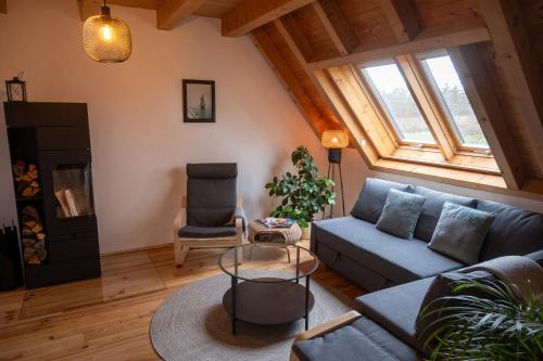 a living room with a couch and a table at FeWo Dattingen am Dorfrand mit Parkplatz, Wlan und Kamin 