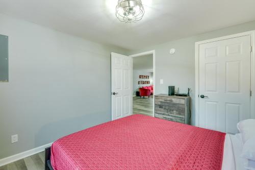 a bedroom with a pink bed and a mirror at Comfy Kingsport Apartment - Walk to Brewery! in Kingsport