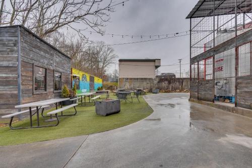 a group of benches and tables in a courtyard at Comfy Kingsport Apartment - Walk to Brewery! in Kingsport