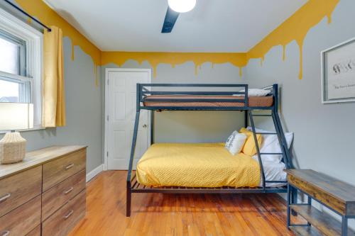 a bedroom with a bunk bed with a yellow wall at Quaint Kingsport Apartment Near Greenbelt Trail! in Kingsport