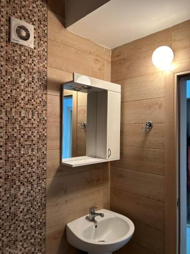 y baño con lavabo y espejo. en Modern Apartment with Panoramic City Views, en Skopje