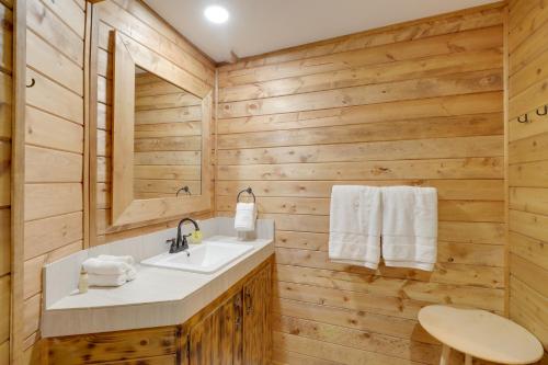 a bathroom with a sink and a mirror at Family-Friendly Riverfront Manor on the Little Red in Heber Springs
