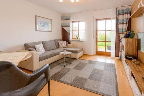 a living room with a couch and a table at Fewo-Harlachberg-Blick-1 in Bodenmais