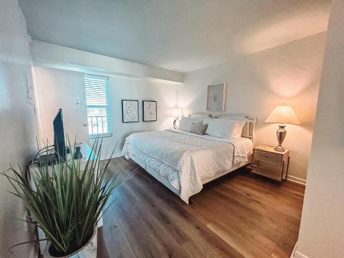 a bedroom with a large bed and a window at Little Miss Magic in Gulf Shores