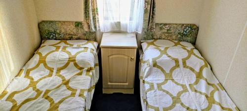 two beds sitting next to each other in a room at Stacaravan Il Piccolo Nido in bosrijke omgeving Eext in Eext