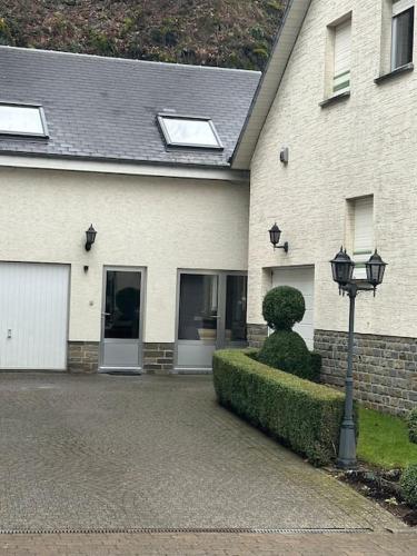 a house with a street light in front of it at Maison au cœur d'Houffalize in Houffalize
