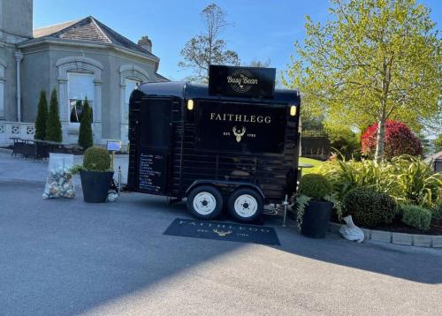 a black semi truck parked in front of a house at Faithlegg Mews in Waterford