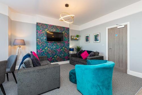 a living room with two couches and a tv at Stylish Seafront Apartment - Sleeps 6 - Gateway to the Lakes in Morecambe
