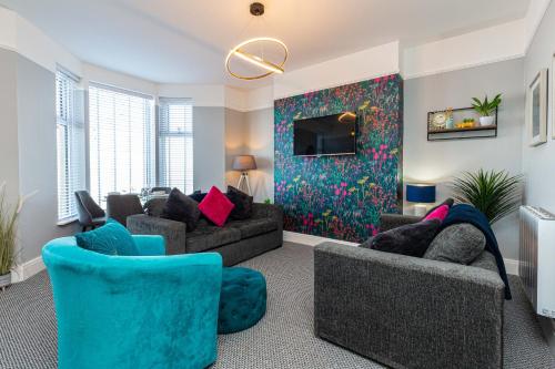a living room with two couches and a tv at Stylish Seafront Apartment - Sleeps 6 - Gateway to the Lakes in Morecambe