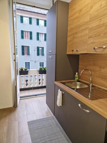 a kitchen with a sink and a window with a building at Appartamento Sofia a Genova in Genova