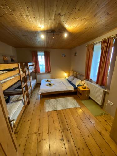 a room with a bed and bunk beds in it at Holiday home Hůrka in Hurka